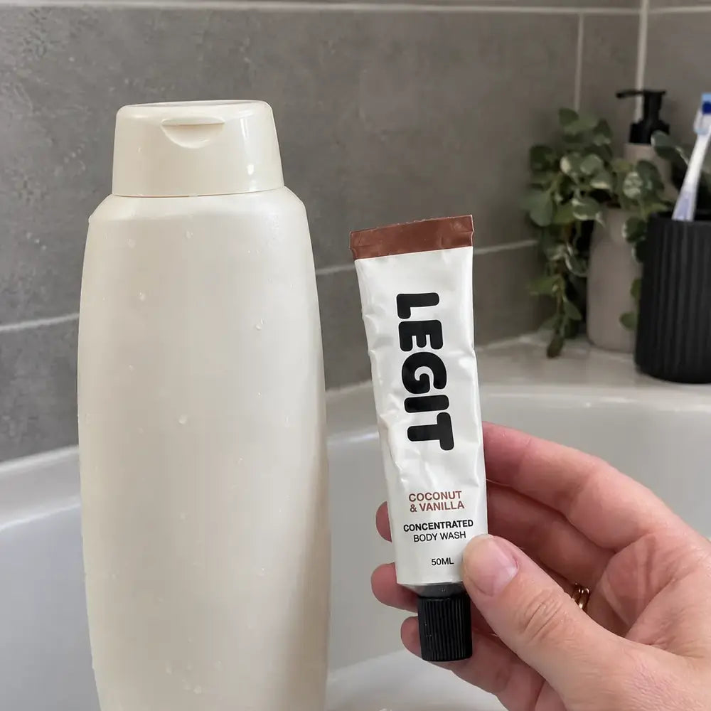 The 50ml tube held next to a large plastic body wash bottle