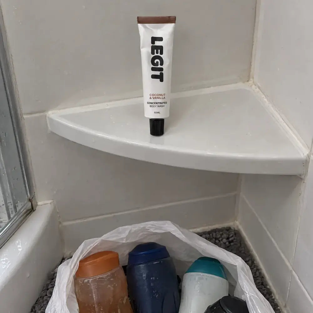 Old plastic shower gel bottles in a bag, one tube on the shelf